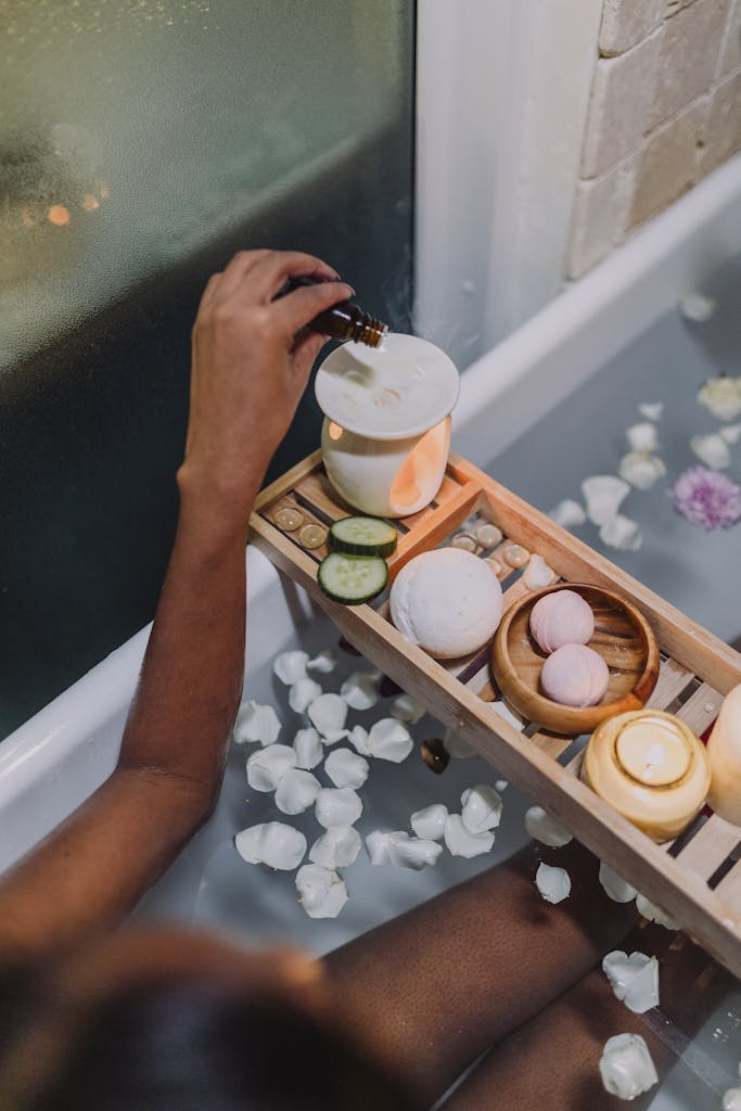 A Person Spa Bathing Dropping Oil on Oil Burner