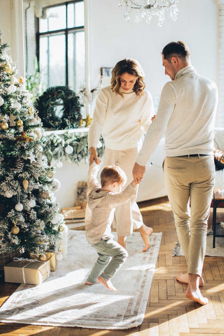 A joyful family bonding around a Christmas tree with gifts, capturing holiday cheer.