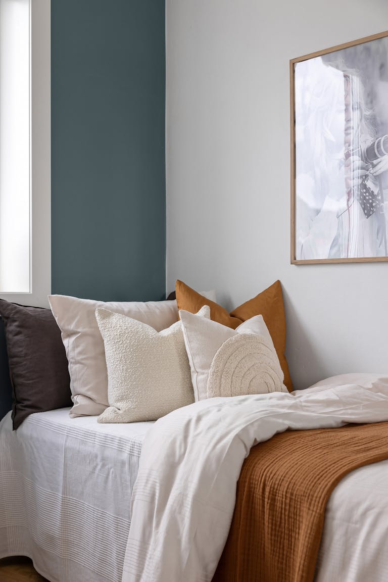 Bedroom with White and Brownish Bed Linen