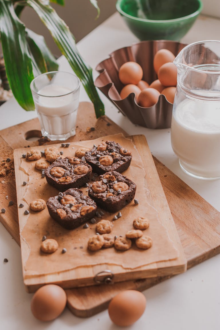 Chocolate brownies with milk and raw eggs, perfect for a cozy baking scene.