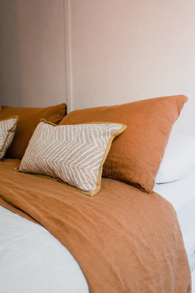 Photo of Brown Pillows on Bed