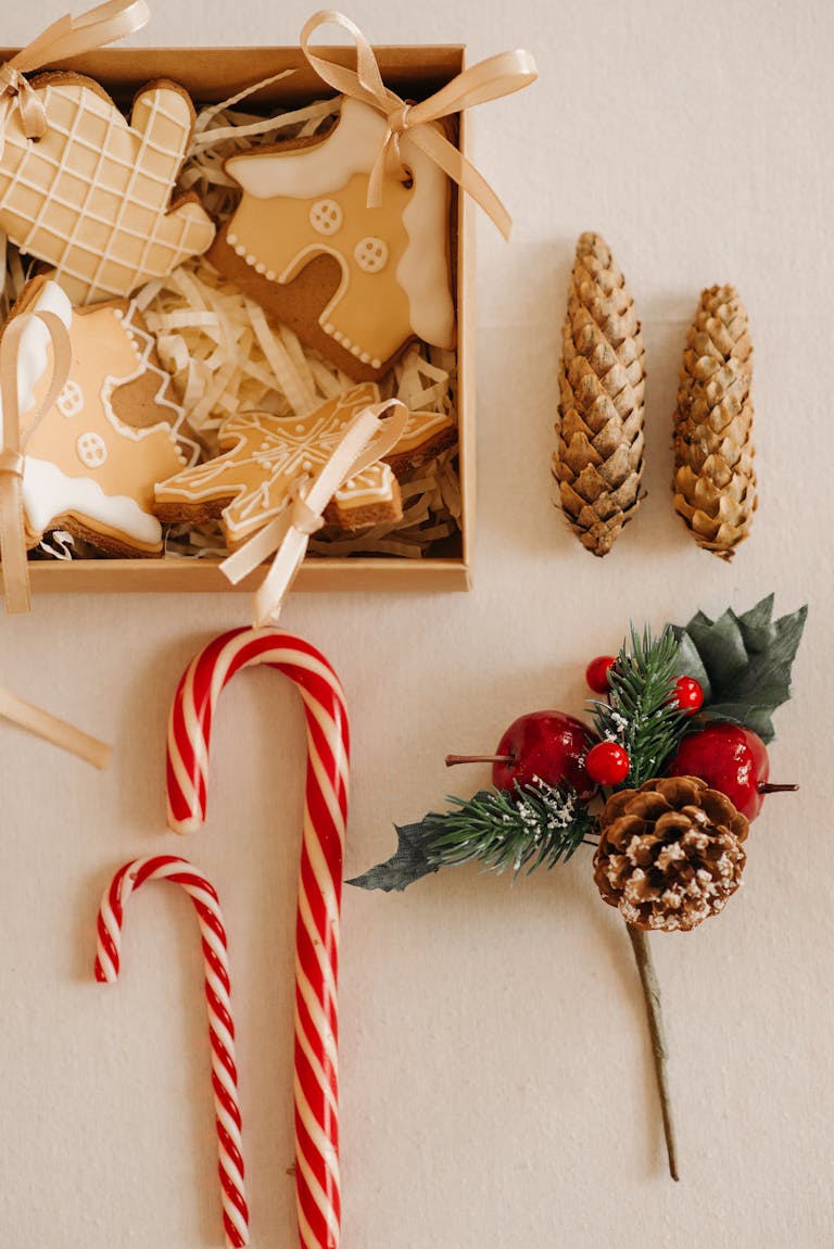 Top view of Christmas cookies, candy canes, and decorations in a cozy holiday setting.