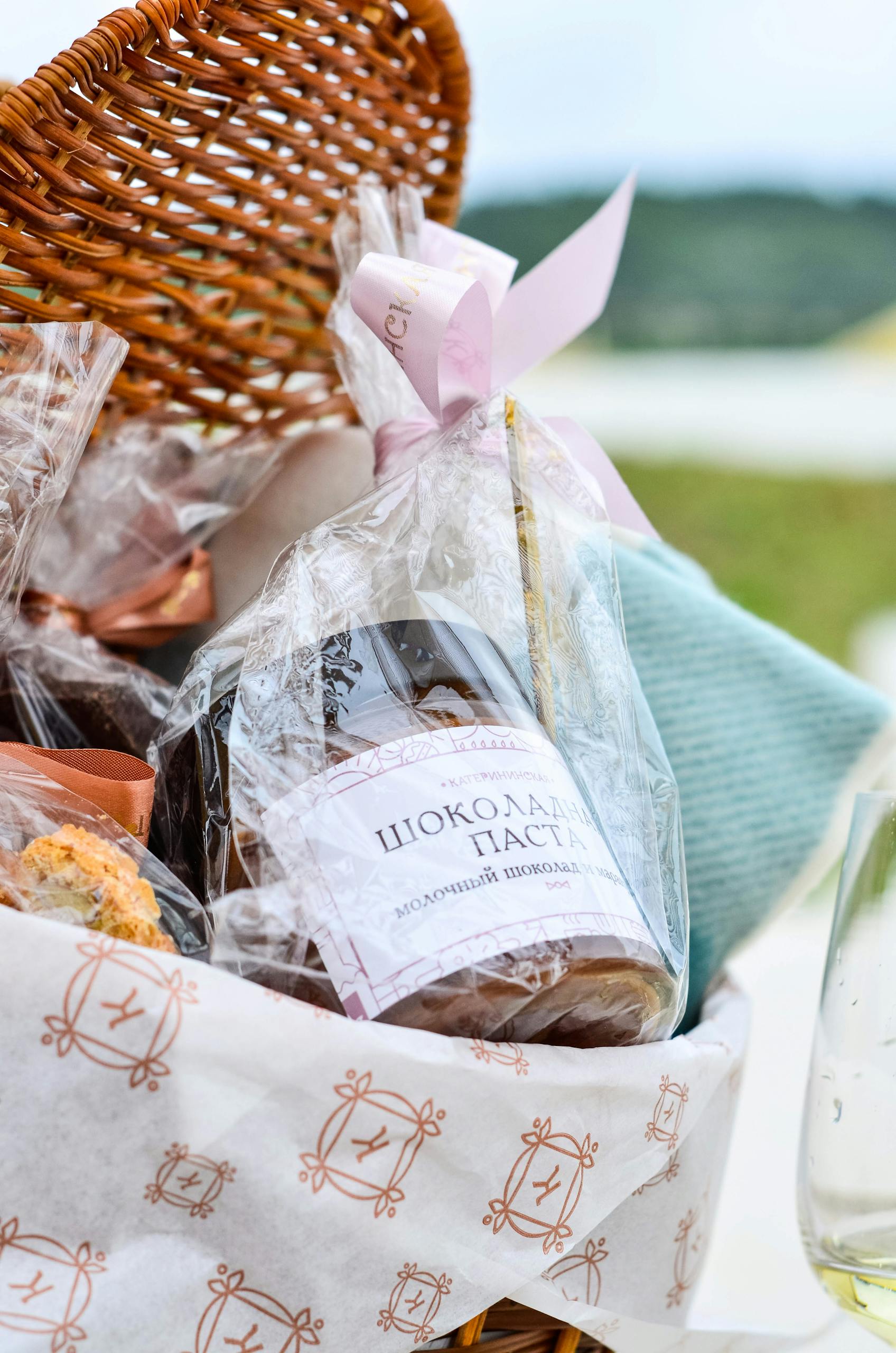 Close-up of a gift basket featuring Russian chocolates, wrapped in foil, perfect for special occasions.