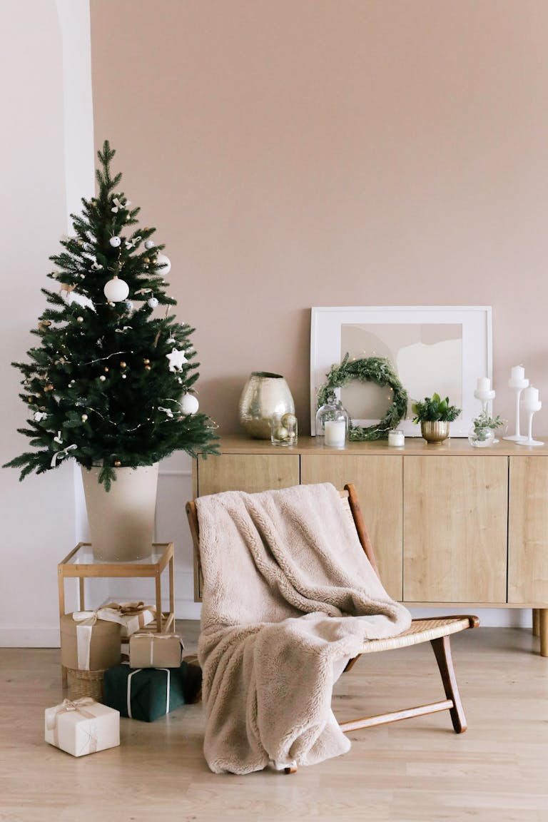 Stylish Christmas tree and gifts in a modern minimalist living room setting.